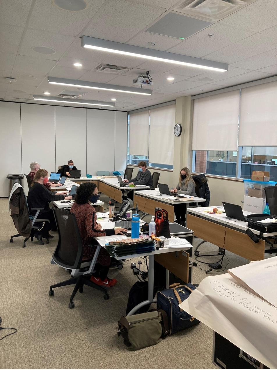 Makeshift data team workspace in a boardroom