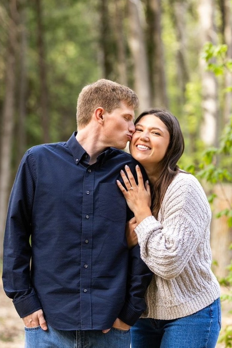 Kyle and Dee sharing a kiss in the forest